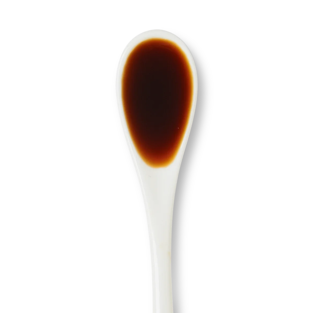 A white ceramic spoon filled with a small amount of dark brown liquid, likely soy sauce, against a white background.