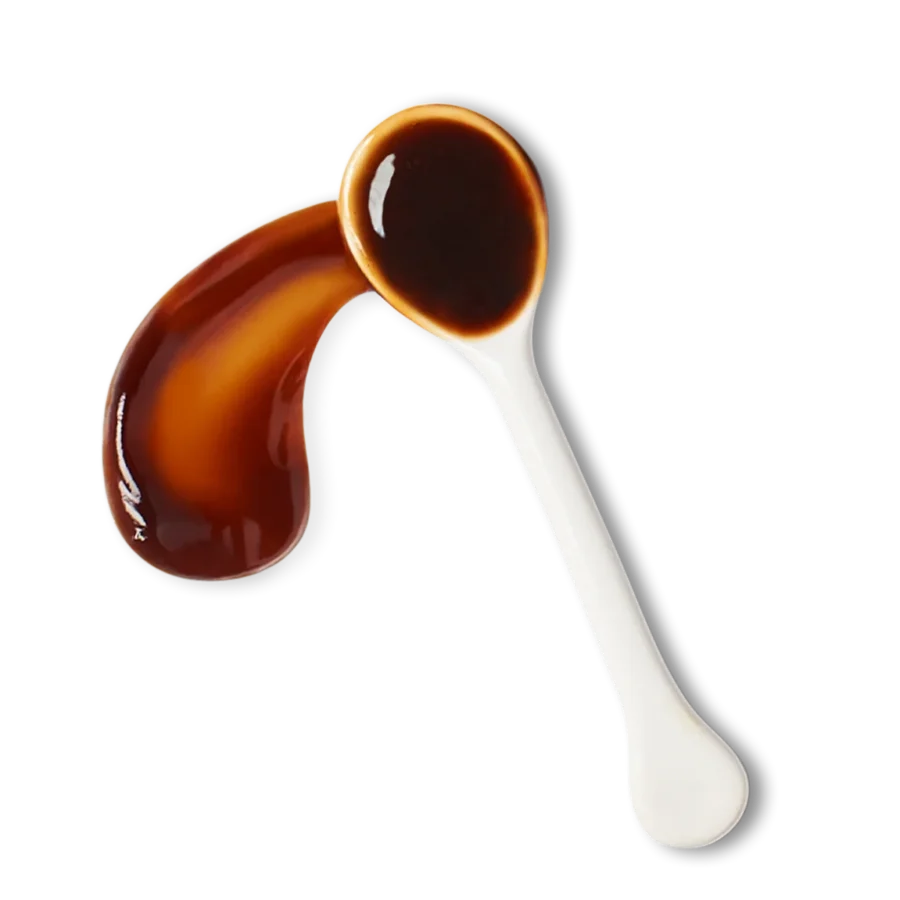 A white spoon filled with dark brown liquid sauce, with some sauce spilled beside the spoon on a white background.