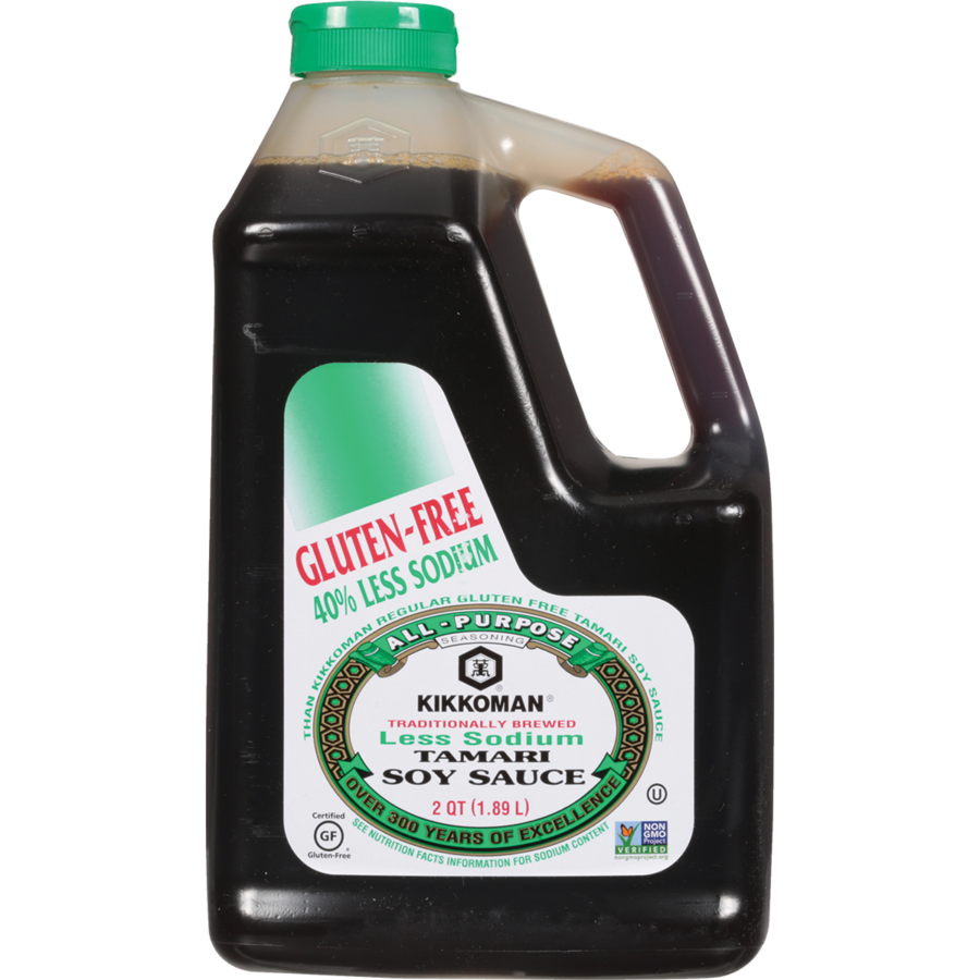 A 64 fl oz plastic jug of Kikkoman Less Sodium Tamari Soy Sauce, labeled gluten-free and 40% less sodium, with a green cap and handle.
