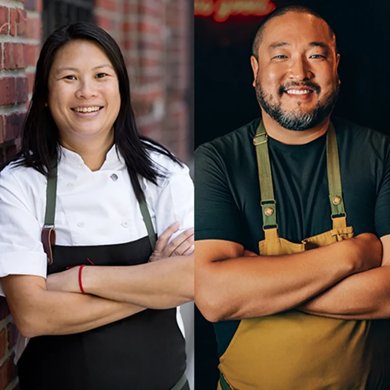 Two chefs stand side by side, each with arms crossed and smiling, against different backgrounds; one wears a white chef coat, the other a black shirt with a green apron.