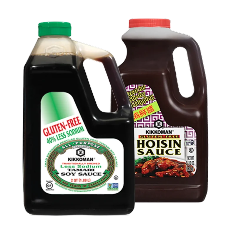 Two large plastic bottles: one of Kikkoman gluten-free tamari soy sauce and one of Kikkoman hoisin sauce, both with handles and labels facing forward.
