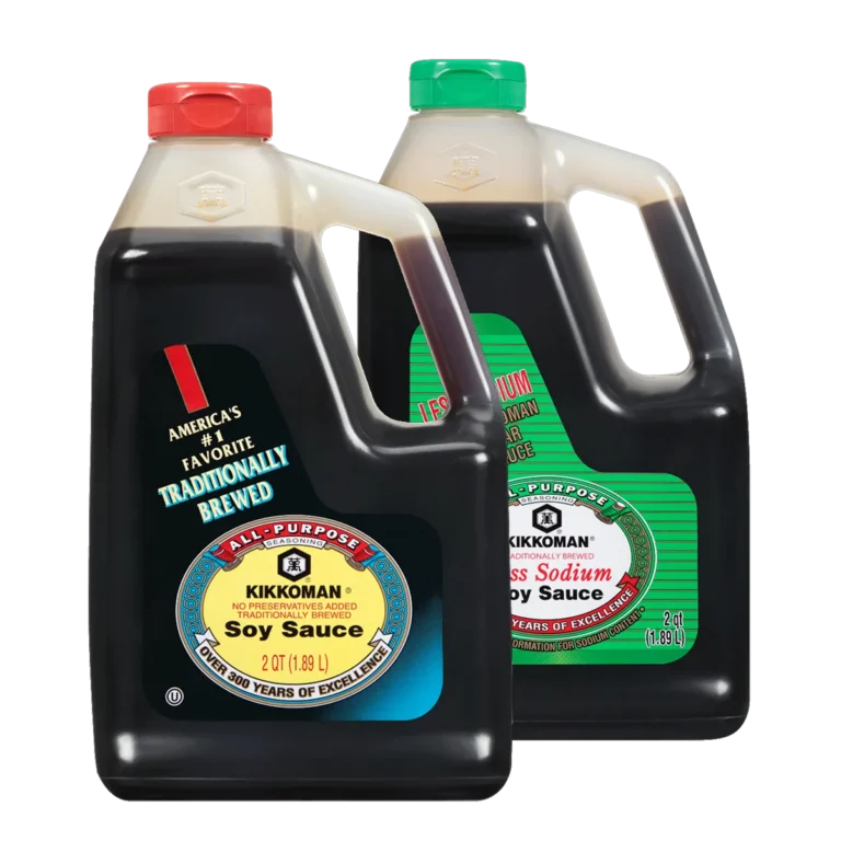Two large plastic jugs of Kikkoman soy sauce, one regular and one less sodium, each with handle and screw cap, placed side by side.