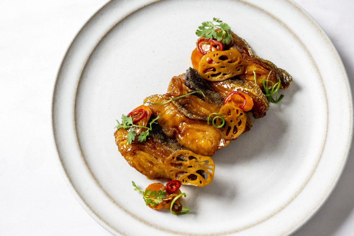 Golden fried sablefish served with marinated lotus root, carrots, and shallots in a soy–vinegar glaze made with Kikkoman® Sushi Sauce (Unagi Tare).