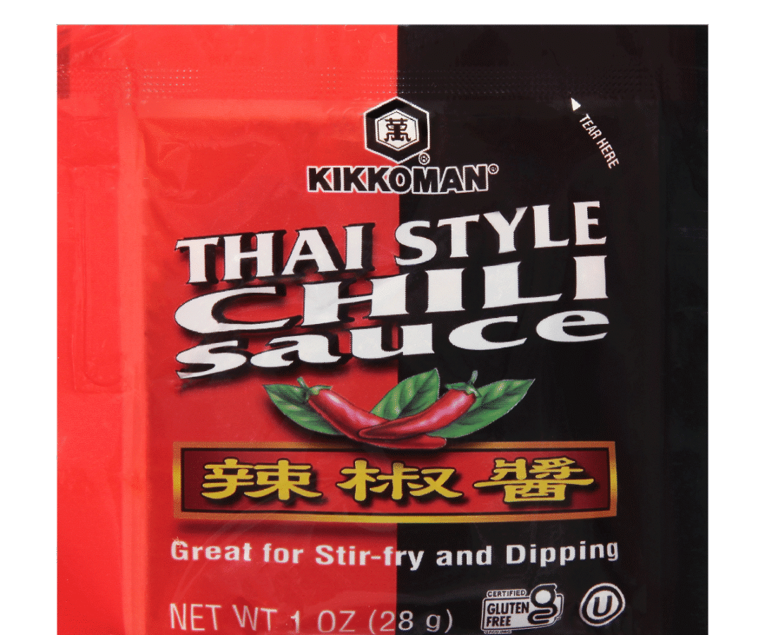A packet of Kikkoman Thai Style Chili Sauce featuring images of red chili peppers and text stating it's great for stir-fry and dipping.