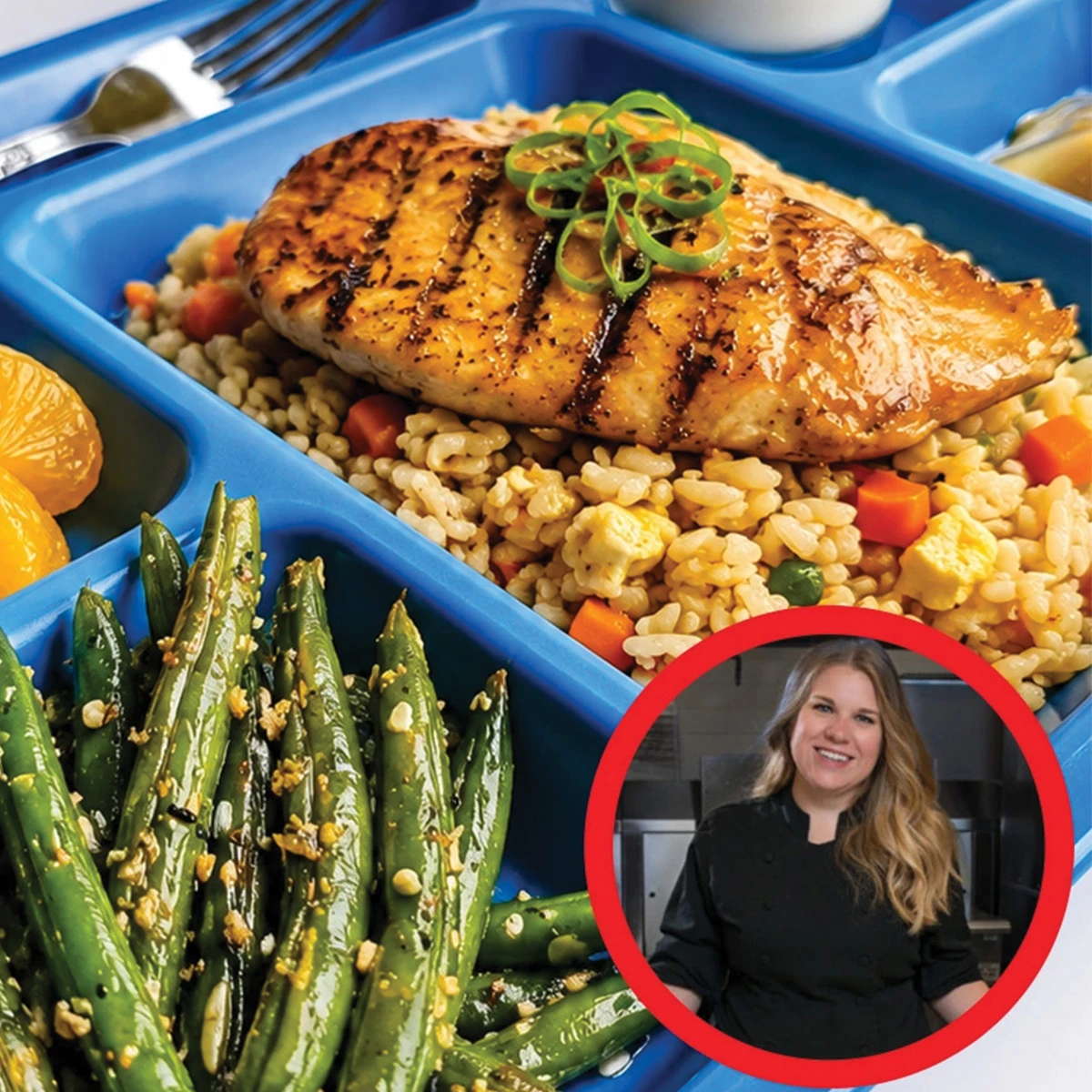 A blue tray with grilled chicken on rice and vegetables, green beans, orange slices, and sauce. Inset shows a smiling woman in a black chef's coat inside a red circle.