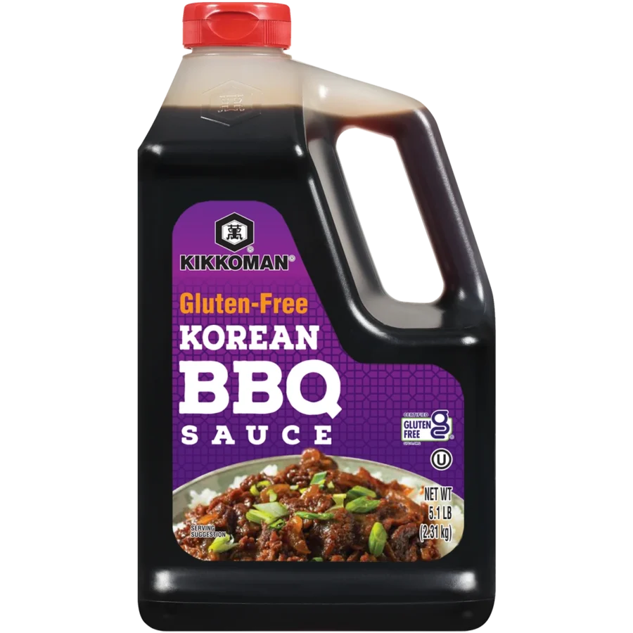 A large plastic bottle of Kikkoman Gluten-Free Korean BBQ Sauce with a red cap and a food image on the label.
