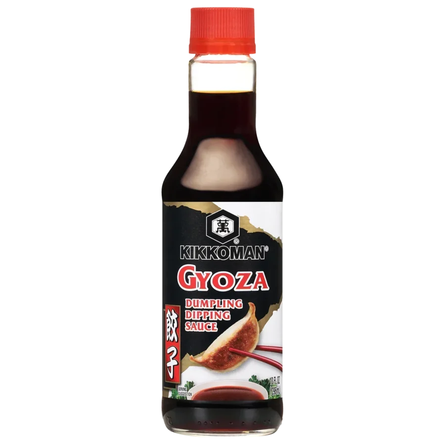 A bottle of Kikkoman Gyoza Dumpling Dipping Sauce with a red cap and an image of dumplings on the label.