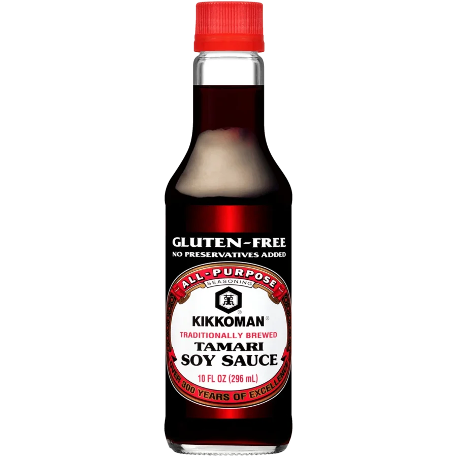 A bottle of Kikkoman Tamari Soy Sauce, labeled gluten-free and traditionally brewed, with a red cap and 10 fl oz (296 ml) capacity.