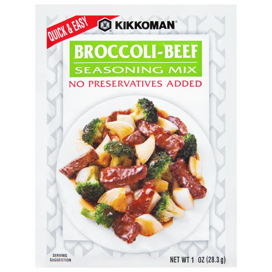 Front of a Kikkoman Broccoli-Beef Seasoning Mix packet showing a serving suggestion of beef, broccoli, and onions on a plate. Text notes "No Preservatives Added" and net weight of 1 oz.