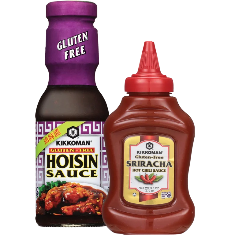 Two bottles of Kikkoman gluten-free sauces: Hoisin Sauce in a glass bottle with a purple cap and Sriracha Hot Chili Sauce in a plastic squeeze bottle with a red cap.