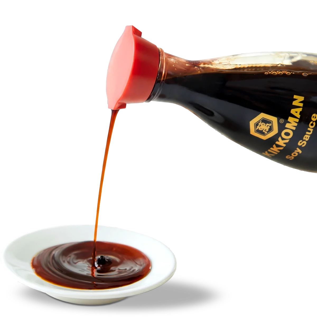 Soy sauce being poured from a Kikkoman bottle into a small white dish.