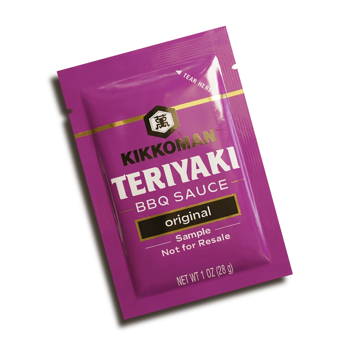 A purple 1 oz packet of Kikkoman Teriyaki BBQ Sauce labeled "original" and "Sample Not for Resale.