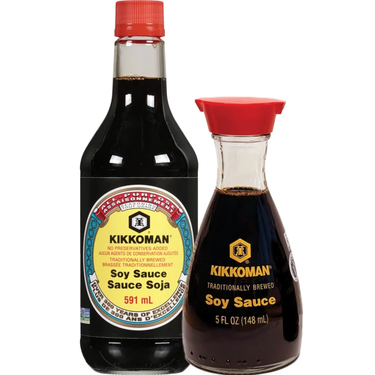 Two bottles of Kikkoman soy sauce: a 591 mL plastic bottle with a red cap and label, and a 148 mL glass dispenser with a red pour spout and yellow label.